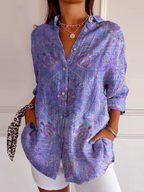 Person wearing a purple patterned shirt with a white background