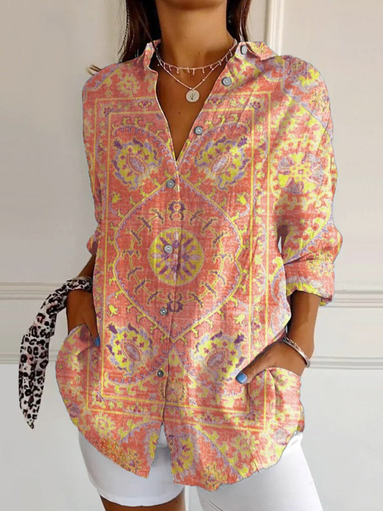 Woman wearing a colorful patterned shirt with a white background
