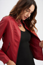 Woman wearing a red leather jacket on a white background
