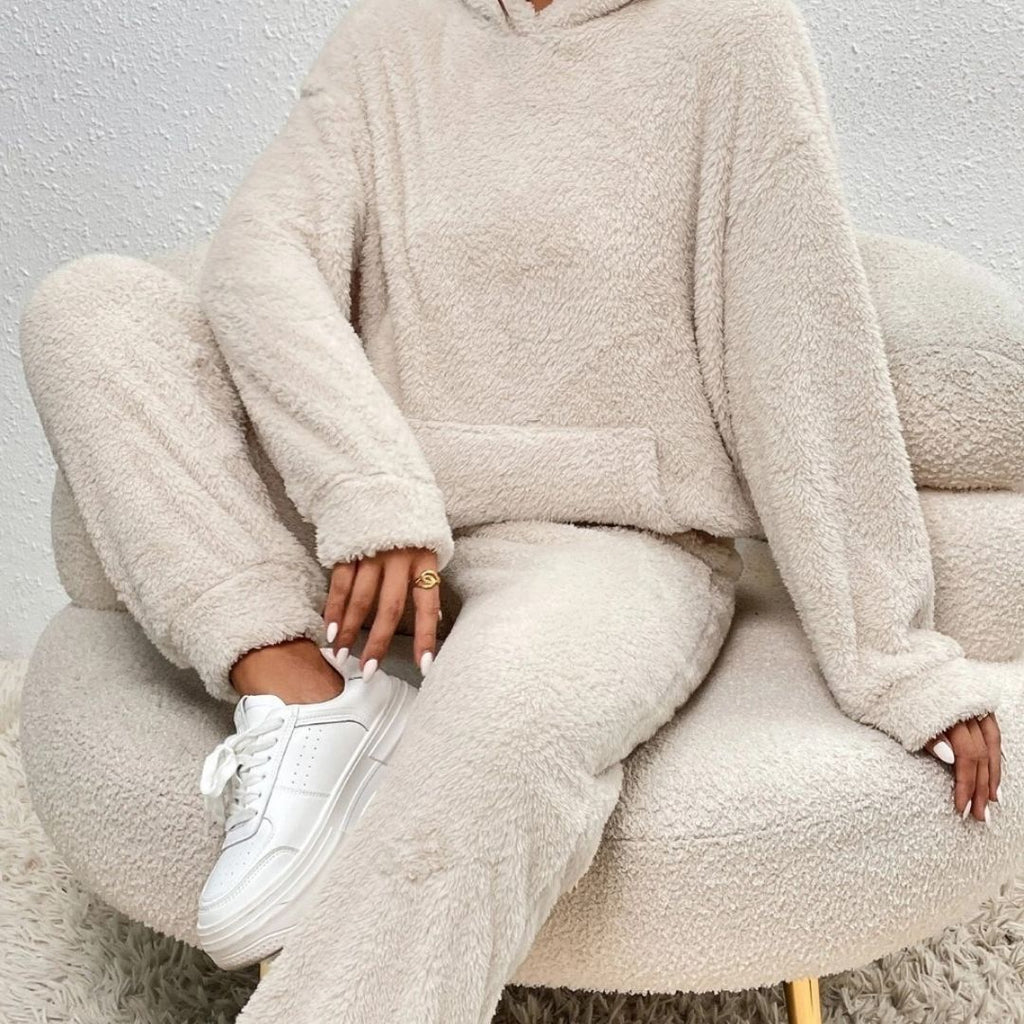 Person wearing a beige fleece outfit sitting on a matching chair.