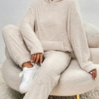 Person wearing a beige fleece outfit sitting on a matching chair.