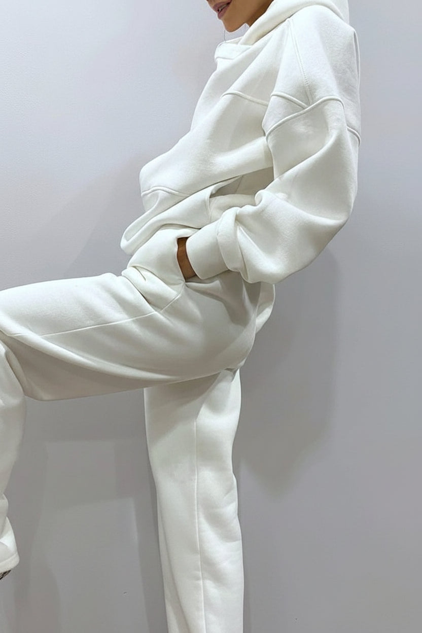 White hoodie and pants set on a plain background
