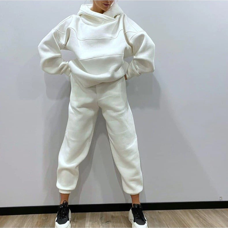 Person wearing a white tracksuit against a plain background