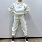 Person wearing a white tracksuit against a plain background