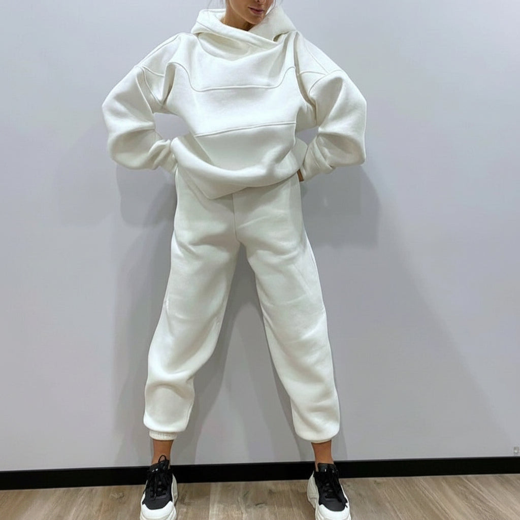 Person wearing a white tracksuit against a plain background