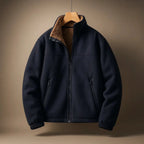 Navy blue jacket with brown interior lining on a wooden hanger against a beige background