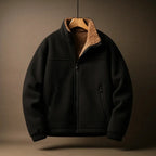 Black jacket with brown sherpa lining on a beige background