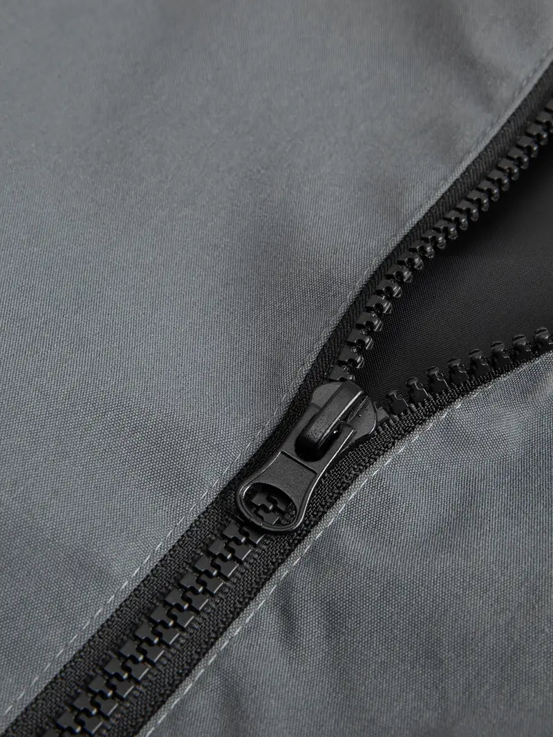 Close-up of a black zipper on a gray fabric surface