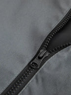 Close-up of a black zipper on a gray fabric surface