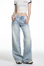 Person wearing light blue jeans and a white top on a white background