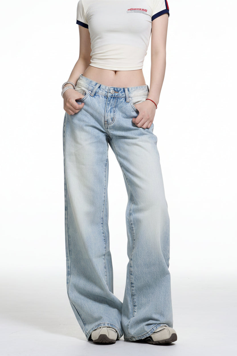 Person wearing light blue jeans and a white top on a white background