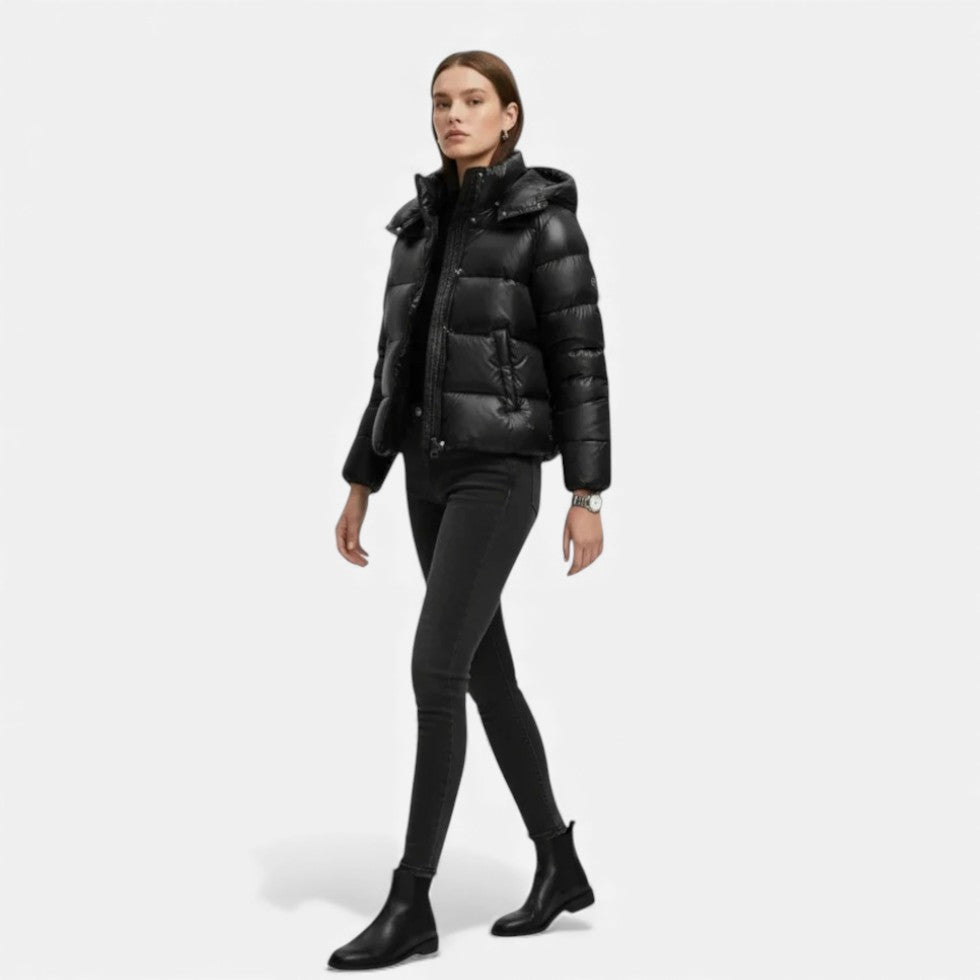 Woman wearing a black puffer jacket on a white background