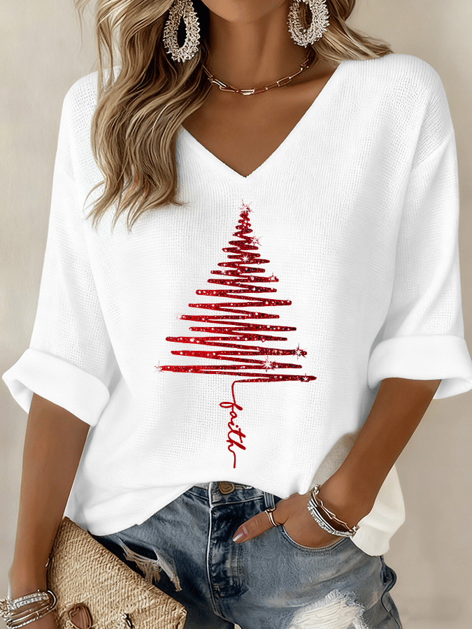 White t-shirt with red Christmas tree design and 'Faith' text, worn by a person.