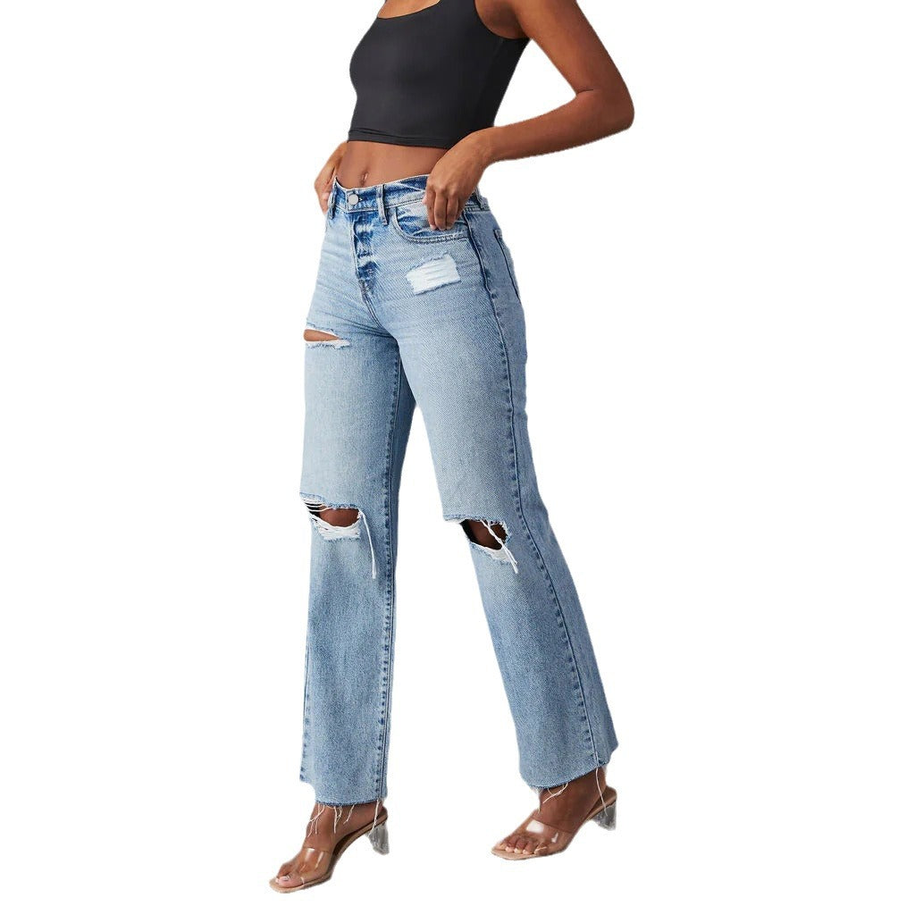 Person wearing ripped blue jeans on a white background