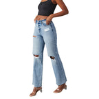 Person wearing ripped blue jeans on a white background