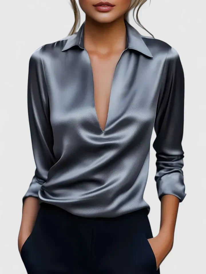 Silver satin blouse worn by a model on a plain background