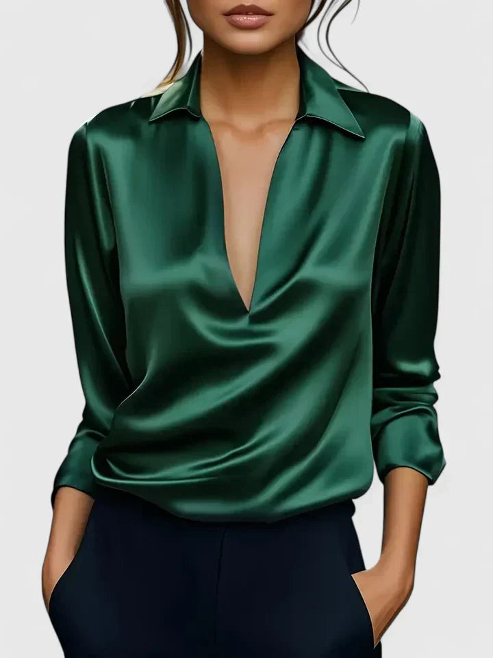 Green satin blouse worn by a model on a white background
