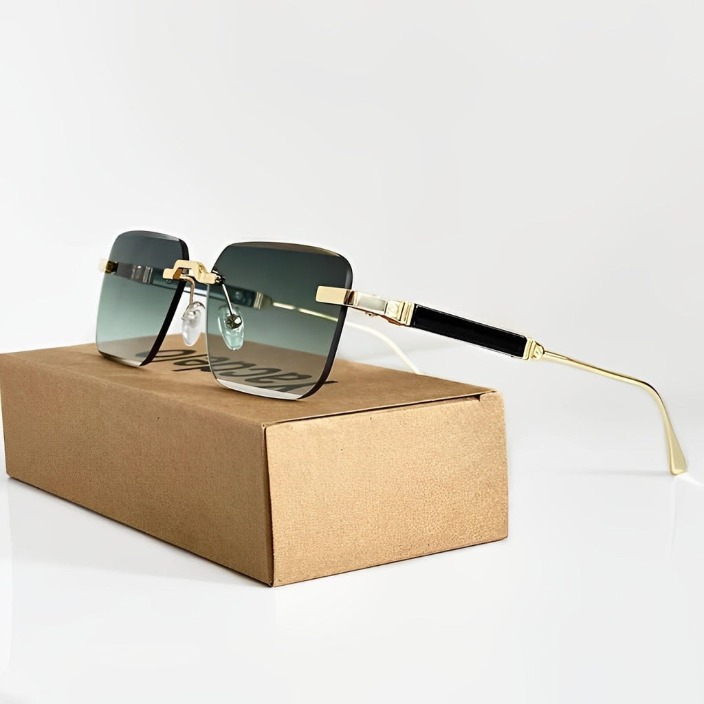 Sunglasses with gold frame and black lenses on a cardboard box against a light gray background