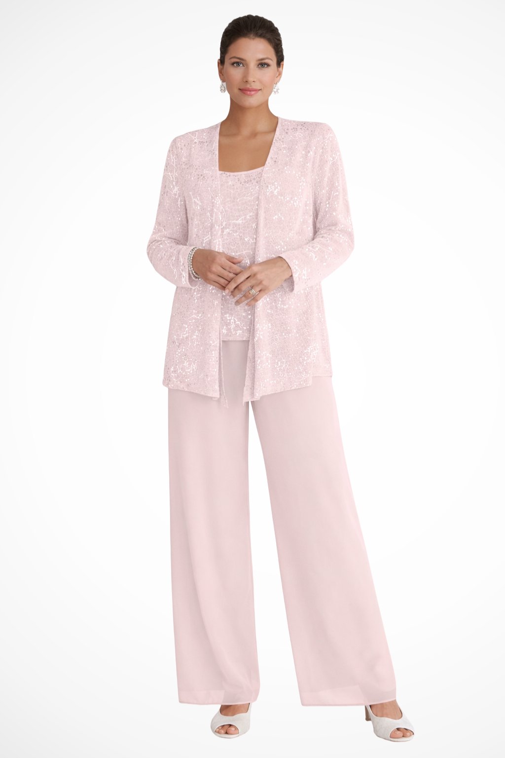 Woman wearing a light pink outfit with a matching jacket on a white background