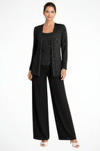 Woman wearing a black outfit with a textured jacket on a white background